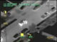 Image of suspect who eventually shot himself bailing from a car rolling to a stop