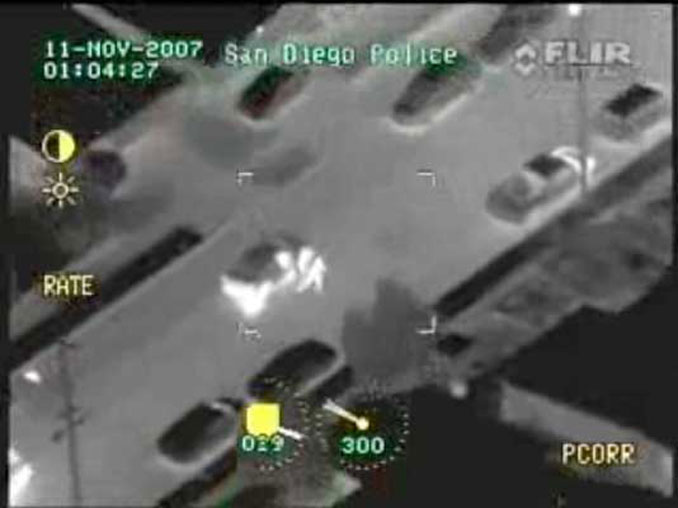 Image of suspect who eventually shot himself bailing from a car rolling to a stop
