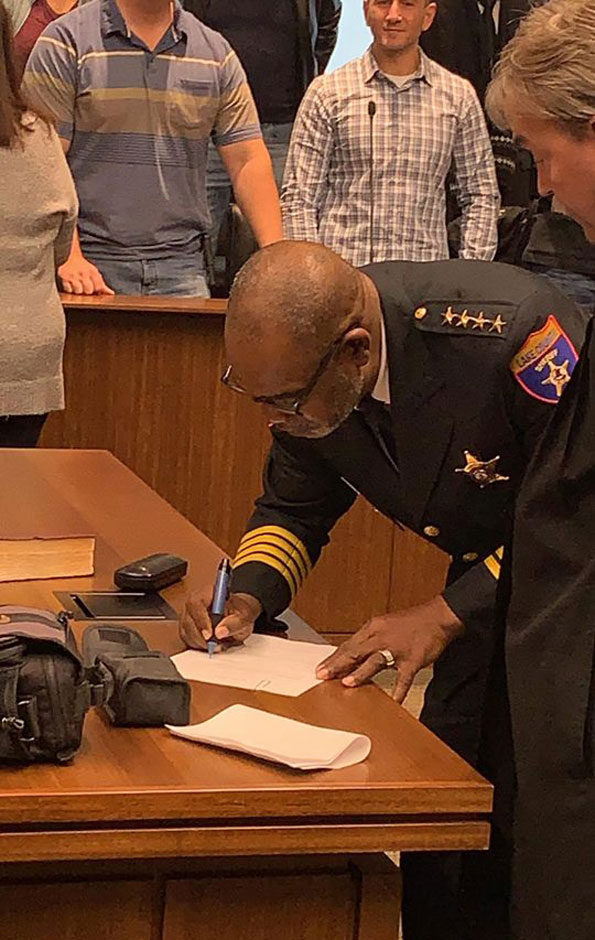 Sheriff John Idleburg signing