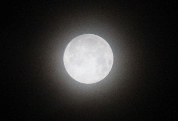Snow Moon SuperMoon with thin cloud veil at 5:30 a.m. Tuesday, February 19, 2019