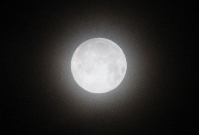 Snow Moon SuperMoon with thin cloud veil at 5:30 a.m. Tuesday, February 19, 2019