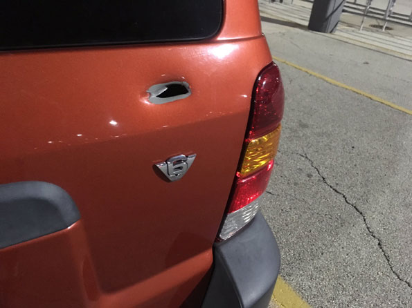 Bullet hole in Ford Escape at Walmart shooting scene Bullet hole in Ford Escape at Walmart shooting scene
