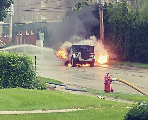 Jeep on fire after being ignited from radiant heat of gas flame out of ground