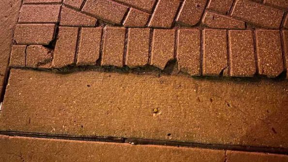 Cracked bricks at edge of corner at Northwest Highway and Arlington Heights Road