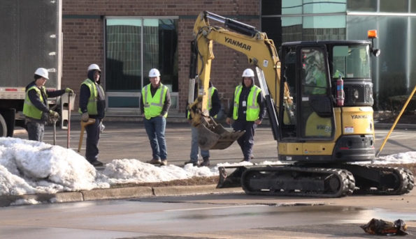 Nicor with an excavator at the scene of a truck crash that ruptured a natural gas line