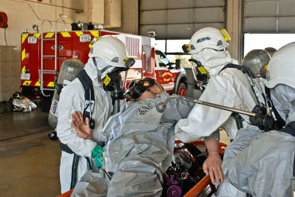 Illinois Army National Guard soldiers practice decontamination procedures while in protective gear during an exercise at the 182nd Airlift Wing in Peoria, Illinois