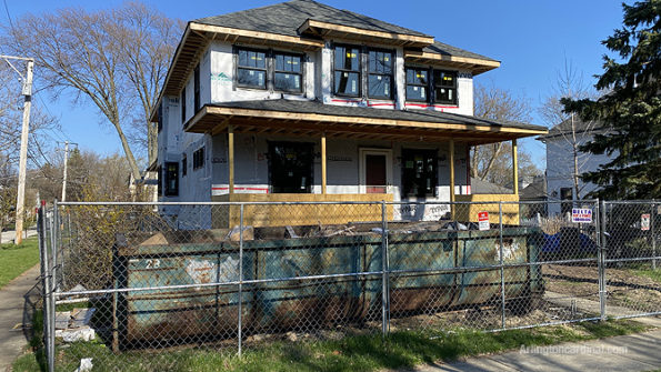 Illegal dumping at residential construction site dumpster