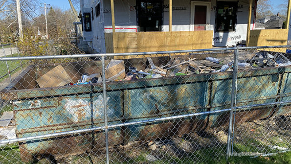 Illegal dumping at residential construction site dumpster