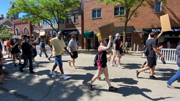 Check Your Privilege poster with protester on Campbell Street in Arlington Heights, Illinois