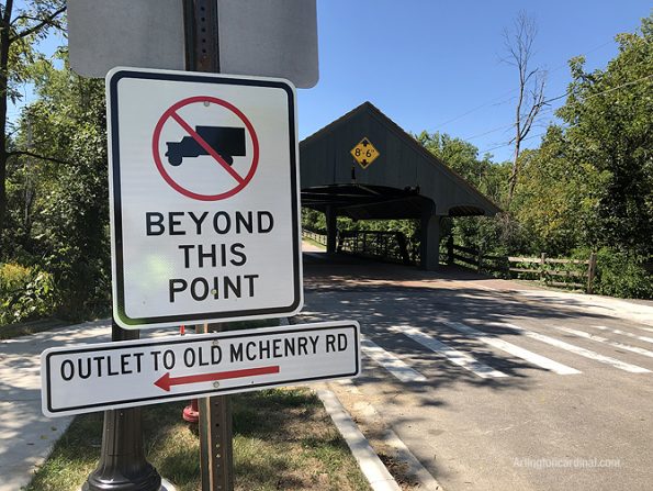 NO TRUCKS BEYOND THIS POINT sign is located on the left side of the road — not on both sides of Robert Parker Coffin Road, or not on the right side of the road where the sign(s) should be located