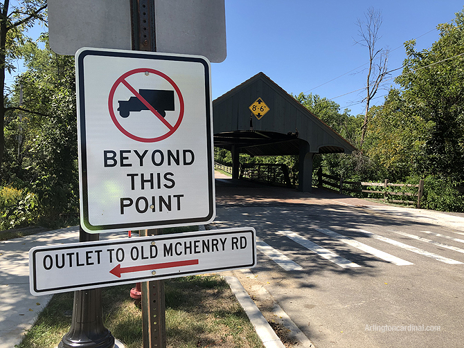 NO TRUCKS BEYOND THIS POINT sign is located on the on the left side of the road — not on both sides of Robert Parker Coffin Road, or not on the right side of the road where the sign(s) should be located