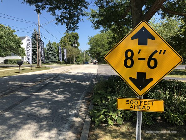 Warning sign is located on a crest in the road where driver's are focused on the possibility of oncoming traffic that is not visible on the other side of the crest