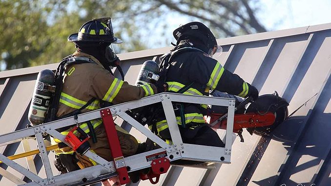 Roof operations with a K-12 circular saw at strip mall fire in Mundelein Wednesday, September 2, 2020 (PHOTO CREDIT: J. Kleeman)