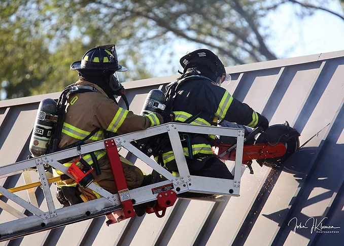 Roof operations with a K-12 circular saw at strip mall fire in Mundelein Wednesday, September 2, 2020 (PHOTO CREDIT: J. Kleeman)