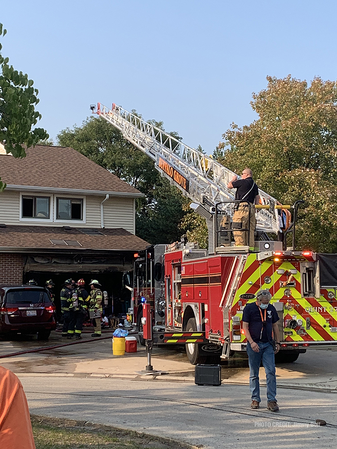 Main aerial over the roof of townhouse at attached garage fire on Pine Tree Circle North in Buffalo Grove