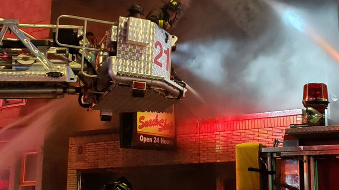 Belmont Snack Shop fire with CFD Tower Ladder 21 at the front of the building (Chicago Fire Media)