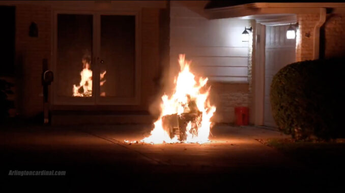 Trash can fire after passerby moved burning can away from underneath garage soffit at home on Euclid Avenue in Arlington Heights