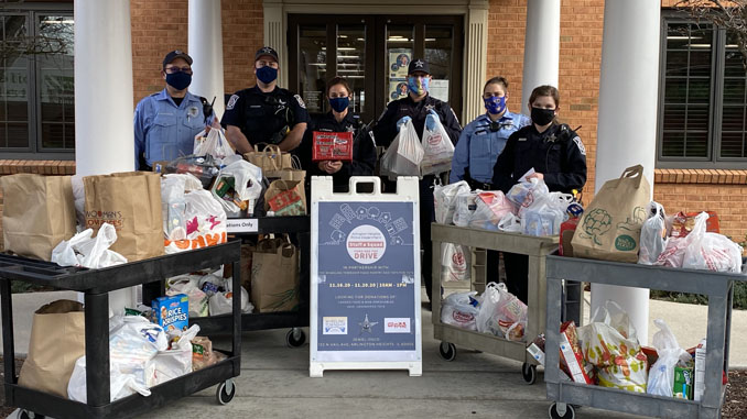 Arlington Heights police personnel with food transport at receiving at Wheeling Township, 1616 North Arlington Heights for the Food and Toy Drive