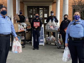 Arlington Heights police personnel with food transport at receiving at the Wheeling Township Food Pantry, 1616 North Arlington Heights for the Food and Toy Drive