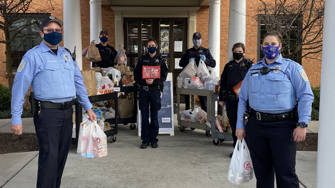 Arlington Heights police personnel with food transport at receiving at the Wheeling Township Food Pantry, 1616 North Arlington Heights for the Food and Toy Drive