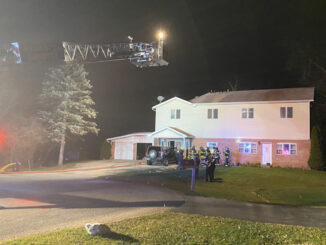 Main aerial ladder raised “just in case” at a house fire on Yale Court in Arlington Heights