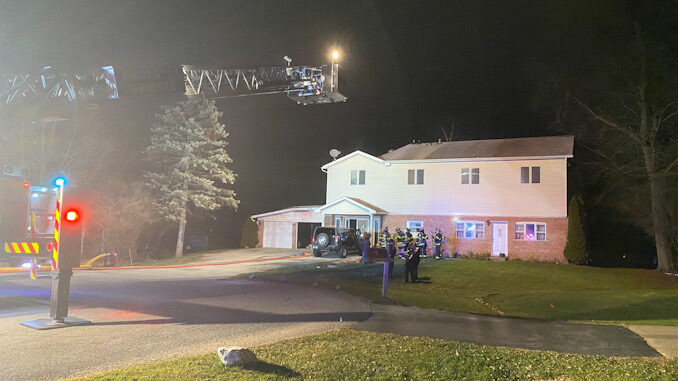 Main aerial ladder raised “just in case” at a house fire on Yale Court in Arlington Heights