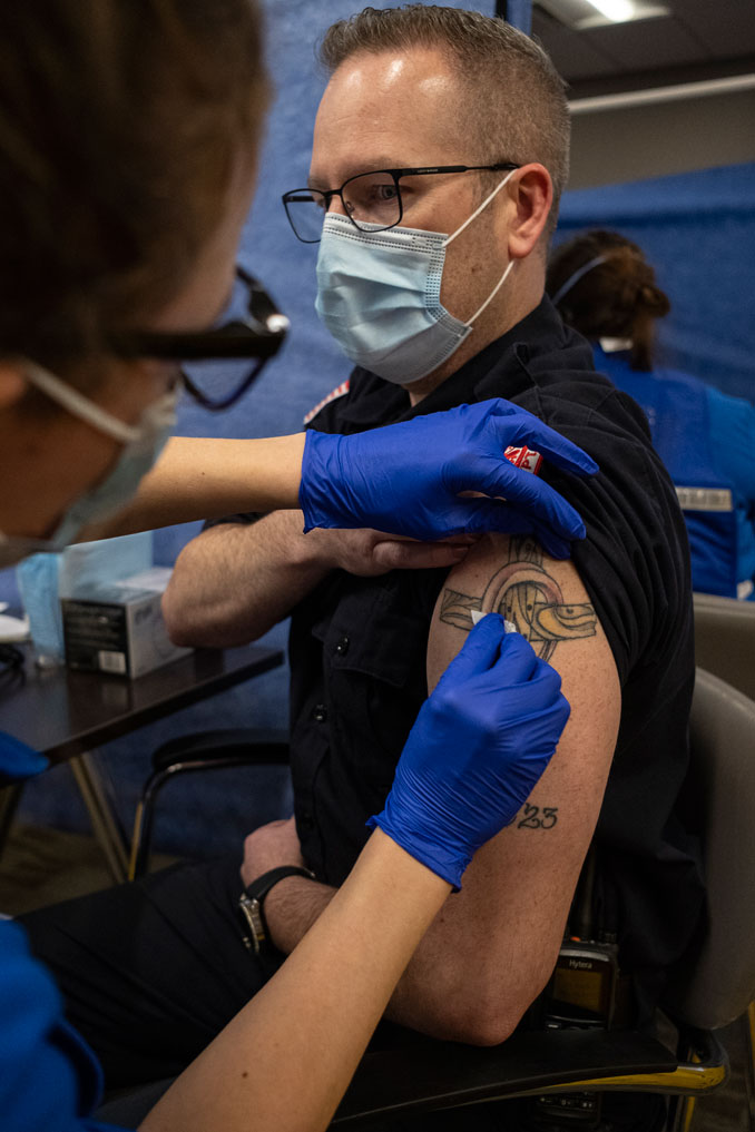 Paramedic and NCH Emergency Preparedness Manager Brian Stennett preparing for COVID-19 vaccination injection