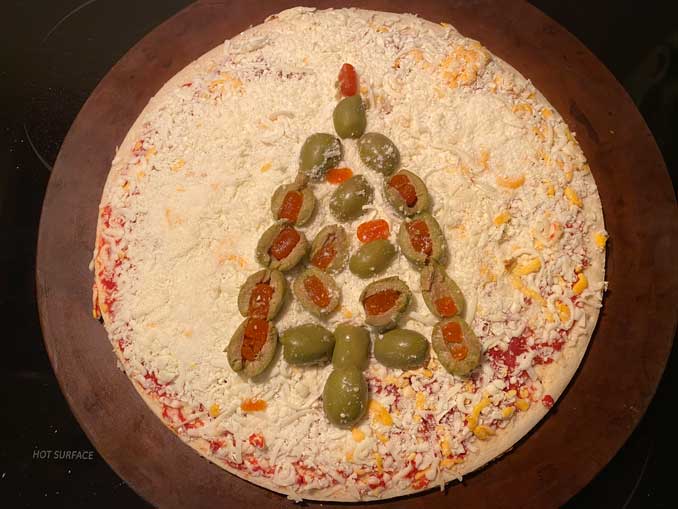 Gino's East Tavern Style Pizza with green olives before baking in the oven