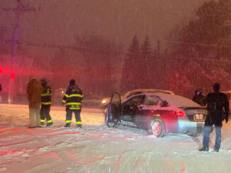 Arlington Heights Fire Department paramedics help a man who was involved in a crash with a snow plow near Hersey High School (Willow Road and Waterman Avenue) about 6:37 p.m.