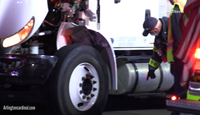 Arlington Heights firefighters inspect a saddle tank that carries diesel fuel after a pedestrian was hit by a box truck on Rand Road between Dryden Avenue and Thomas Street in Arlington Heights