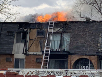Significant fire showing from the roof after it burned off a section of vertical mansard roof at condo apartment fire in Palatine (PHOTO CREDIT: Lance Neuses)