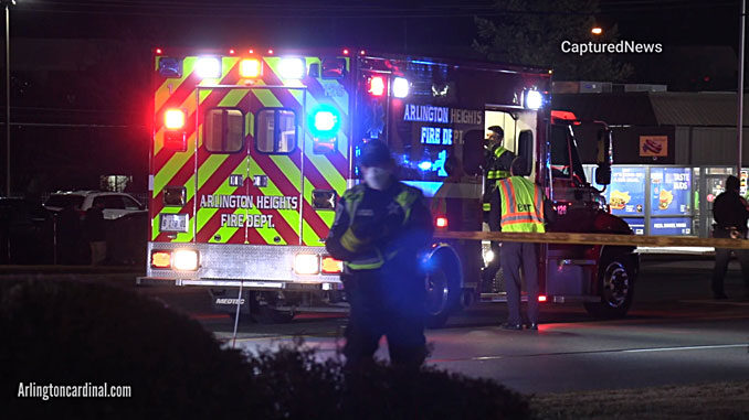 Arlington Heights Fire Department paramedics calling in to hospital while police secure a perimeter around the crash scene on Rand Road