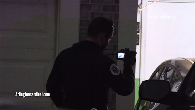 Police take photographs in a garage at the scene of a stabbing on Fawn Lane near Hick Road in Palatine