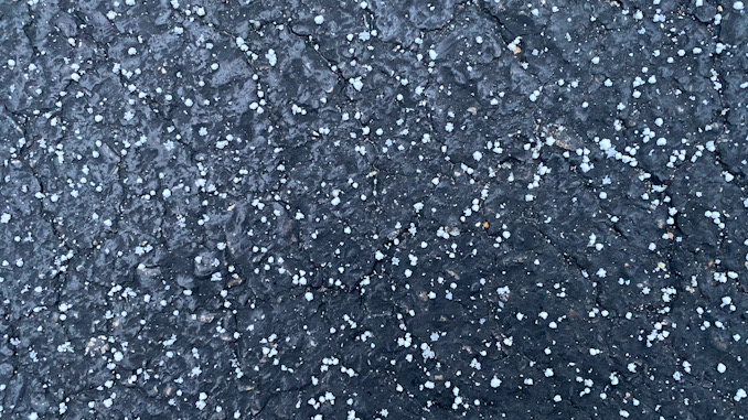Graupel on black asphalt about 4:45 p.m. Monday, January 25, 2021 in Arlington Heights