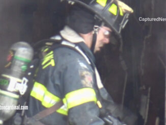 Firefighter working overhaul inside scene of a house fire that killed four girls and her mother