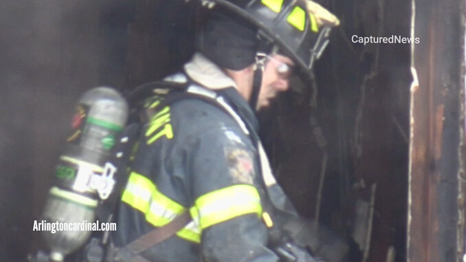 Firefighter working overhaul inside scene of a house fire that killed four girls and her mother