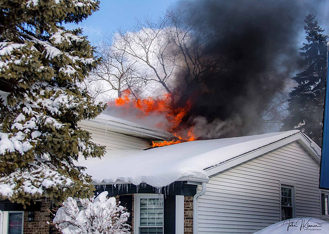 Smoke and flames showing from the back of a house at a house fire on Patton Drive in Buffalo Grove (PHOTO CREDIT: J Kleeman)