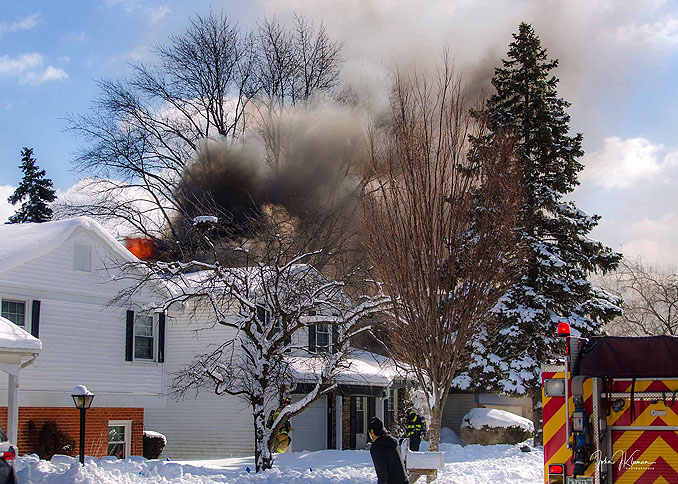 Smoke showing from the back of a house at a house fire on Patton Drive in Buffalo Grove (PHOTO CREDIT: J Kleeman)