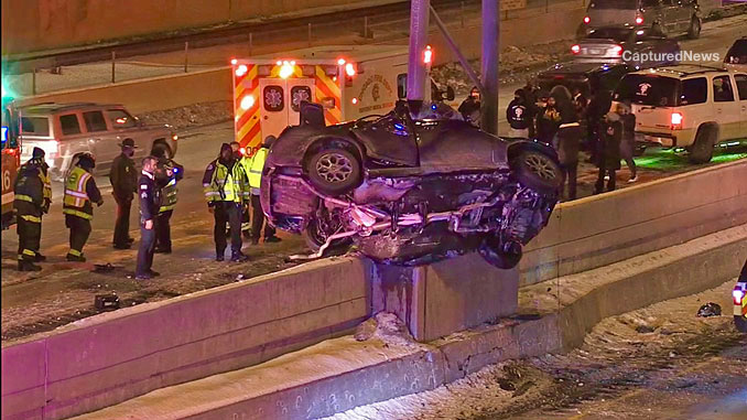 Chrysler 300 with wrapped roof around a sign post pole on the Dan Ryan Expressway