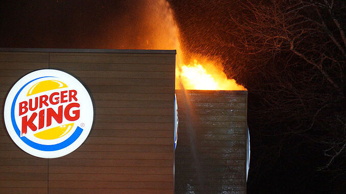 One hand line stream just after fire breaks through the roof at extra alarm fire at Burger King on Rand Road in Lake Zurich (PHOTO CREDIT: Jimmy Bolf).