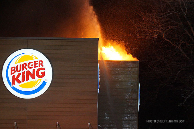 One hand line stream just after fire breaks through the roof at extra alarm fire at Burger King on Rand Road in Lake Zurich (PHOTO CREDIT: Jimmy Bolf).