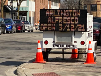 Portable electronic sign board announces Arlington Alfresco opens March 12, 2021.