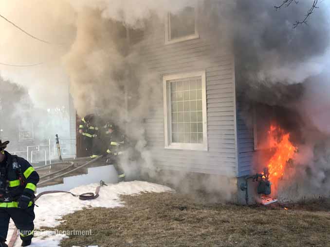 Fire venting from a basement window near a gas meter (SOURCE: Aurora Fire Department)