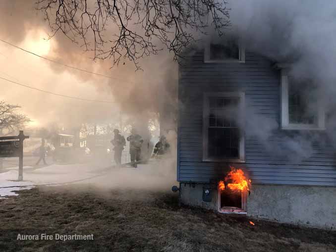 Flames venting from a basement window on Downer Place in Aurora (SOURCE: Aurora Fire Department)