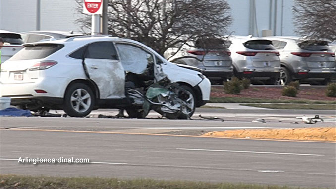 Part of the frame of the motorcycle against the passenger side of the Lexus SUV at Golf Road and National Parkway in Schaumburg