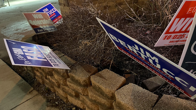 Gina Faso sign bent down at Northwest Highway and Vail Avenue, at the Mobil gas station