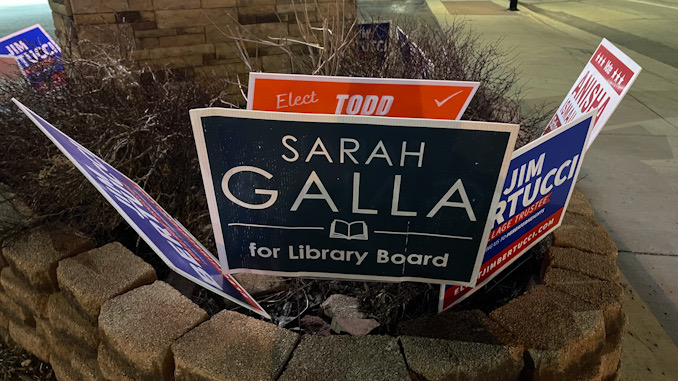 Todd Witherow campaign sign behind Sarah Galla campaign sign