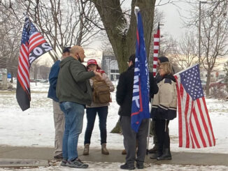 People with Pro-Trump items at the northwest corner of Golf Road and Meacham Road at a demonstration on January 17, 2021 after counter protesters had left the area