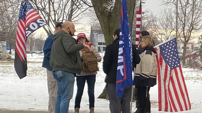 People with Pro-Trump items at the northwest corner of Golf Road and Meacham Road at a demonstration on January 17, 2021 after counter protesters had left the area