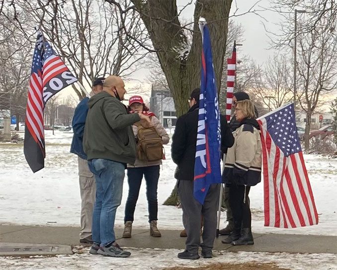 People with Pro-Trump items at the northwest corner of Golf Road and Meacham Road at a demonstration on January 17, 2021 after counter protesters had left the area